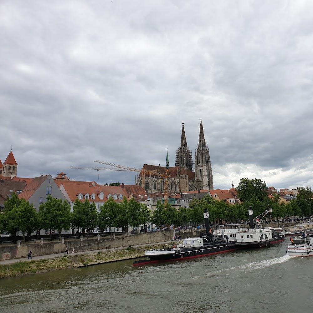 Two boats in front of Regensburg Cathedral.